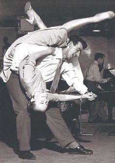 two men are dancing together on the dance floor