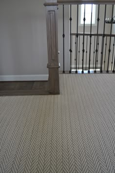 an empty room with carpet and railings