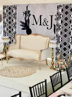 a white couch sitting on top of a table in front of a sign that says m & j