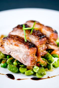 a white plate topped with meat and peas