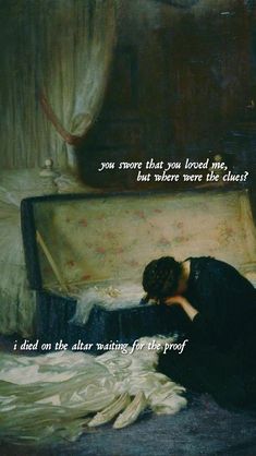 a woman laying on top of a bed next to a painting with a quote above it