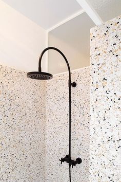 a shower head and hand shower in a bathroom