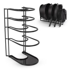 a black metal rack with four plates on it