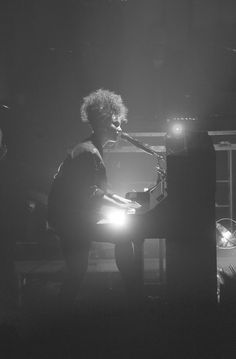 black and white photograph of a man playing the piano