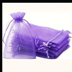 purple organ bags are stacked on top of each other