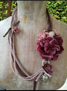 a mannequin with flowers and beads on it