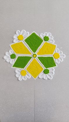 a white and yellow flower design is on the floor