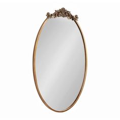 a gold oval mirror with an ornate design