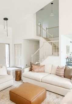 a living room filled with furniture and a stair case