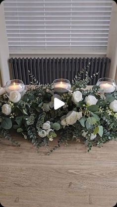 flowers and candles are arranged on a table