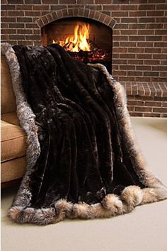 a blanket that is sitting in front of a fire place