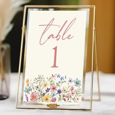 a table number card holder with flowers on it