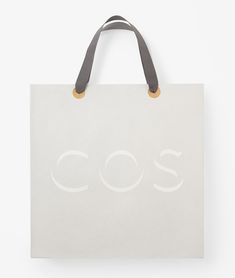 a white bag with the word cos printed on it