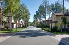 an empty street lined with houses and trees