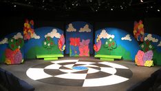 the stage is set up for a show with cartoon characters painted on it's walls