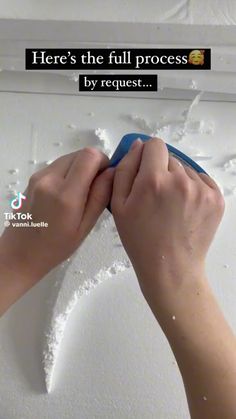 someone using a sponge to paint the wall with white paint and advertise it