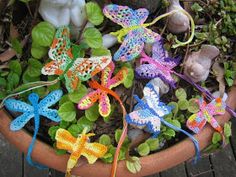 small crocheted dragon figurines in a flower pot