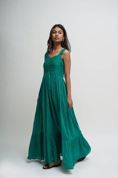 Experience freedom in our sleeveless empire-waist tiered boho dress, crafted from 100% GOTS Certified Organic Cotton for a breathable and effortless feel. The tiered skirt and full-length silhouette create an elegant yet relaxed flow, making it perfect for weddings, garden parties, and romantic summer outings. Designed for comfort and timeless beauty, this cottagecore-inspired dress offers a flattering fit while ensuring ease of movement. Whether styled for a boho-chic occasion, vacation wear, o Green V-neck Hippie Maxi Dress, Casual Turquoise Maxi Dress With V-neck, Flowy Tie-dye Maxi Dress For Beachwear, Turquoise V-neck Casual Maxi Dress, Bohemian Cotton Tie-dye Maxi Dress, Cotton Long Dress, Layered Dress, Sleeveless Tunic, Dress Sleeveless