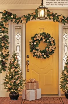 two christmas wreaths on the front door with presents under them