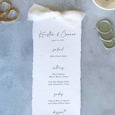 the wedding menu is laid out with scissors