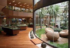 the inside of a large building with lots of plants and rocks on display in it