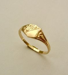 100% AUSTRALIAN MADE BRAND NEW GENUINE SOLID 9ct YELLOW GOLD UNISEX SHIELD SIGNET RING GENUINE SOLID GOLD NOT FILLED - NOT PLATED - NOT HOLLOW HALLMARKED (Stamped) 9ct 375 Ring weight : 1.2 grams approx. Ring width : 7 mm approx. widest point tapering to 2 mm approx. Ring size : L ( AU-UK ) and 6 US FINEST QUALITY HIGHLY POLISHED crafted with Precision    Our QUALITY is GUARANTEED. Buy with confidence. If you are not satisfied for any reason you can return it for a full refund. No postage charge Antique Gold Signet Ring With Diamond Cut, Art Deco Gold Engraved Ring For Gift, Gold Art Deco Engraved Ring As Gift, Gold Engraved Art Deco Ring For Gift, Gold Art Deco 14k Gold Signet Ring, Gold Art Deco Signet Ring For Gift, Gold Art Deco Signet Ring Gift, Gold Art Deco Rings With Hallmarks, Signet Rings Women