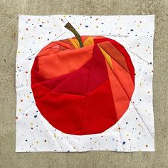 an orange and red patchwork pumpkin on a white background