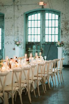 a long table is set with candles and flowers