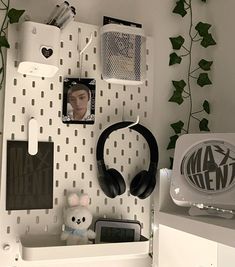 a white desk with headphones on top of it