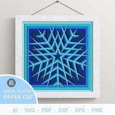 a blue paper cut snowflake hanging on a wall next to a sign that says digital file for paper cut