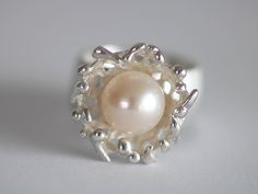 Unique ring in silver with a beautiful white pearl Size/Dimensions: Ring size 54.5 - 55 / 17.2 / 6.75 Ring rail 9.5 mm Overall width 19mm Ring size expandable up to Gr. 56 Used material: 925 silver Pearl approx. 10 mm Manufacturing method: Goldsmith handwork Unique Pearl Jewelry For Anniversary, Unique Pearl White Jewelry For Wedding, Unique Sterling Silver Pearl Ring For Wedding, White Pearl Ring For Jewelry Making, Unique Handmade Pearl Wedding Ring, Handmade White Gold Pearl Ring For Formal Occasions, Unique White Gold Sterling Silver Pearl Ring, Unique White Pearl Ring For Formal Occasions, Unique Handmade Pearl Ring For Wedding