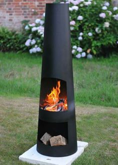 an outdoor fireplace in the middle of a yard