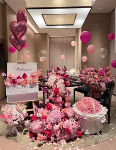 a table with flowers and balloons on it