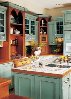 a kitchen filled with lots of green cabinets