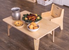 a wooden table with two bowls of food on it and a cookie next to it