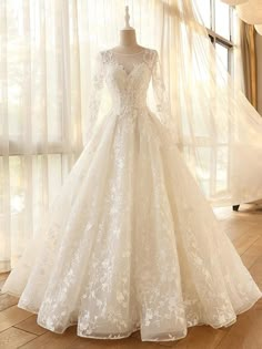 a wedding dress on display in front of a window