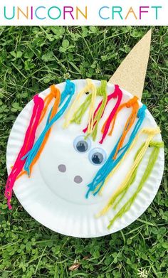 paper plate unicorn craft for kids on the grass with text overlay that says, unicorn craft