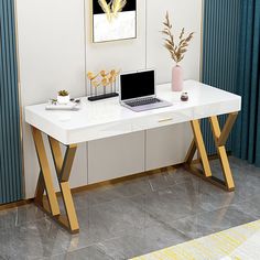 a white desk topped with a laptop computer