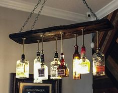 a group of liquor bottles hanging from a light fixture