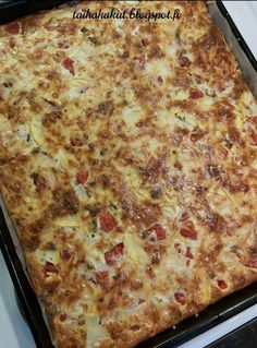 a large square pizza sitting on top of a pan