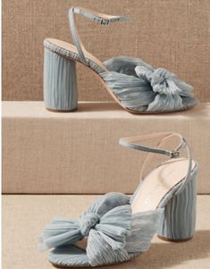 a pair of blue high heeled shoes with ruffles on the toes and ankle