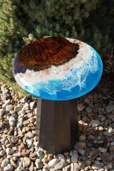 a blue and white table sitting on top of rocks