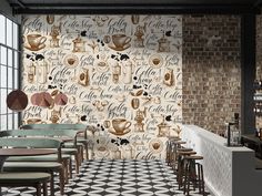 the interior of a coffee shop with tables and stools in front of a brick wall