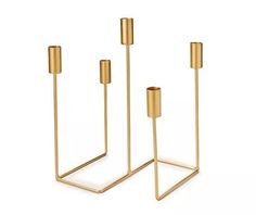 three gold candlesticks on a white background