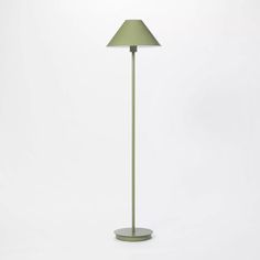 a green floor lamp on a white background