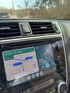 the dashboard of a car with an electronic device in it's center console and gps