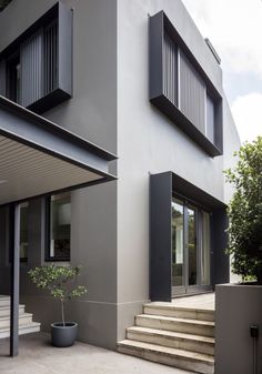 an exterior view of a modern house with stairs