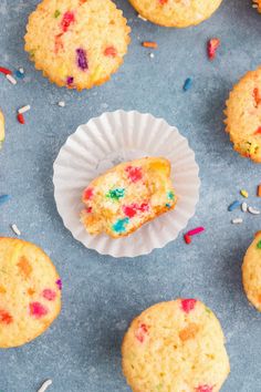 colorful sprinkles are on top of the muffins