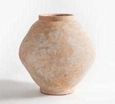 a large vase sitting on top of a white table