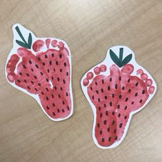 two pieces of paper cut out to look like strawberries